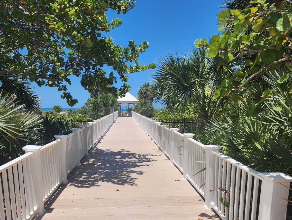 White vinyl picket fence installed along pedestrian walkway in North Central Florida